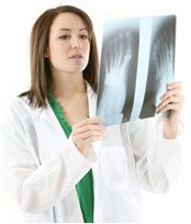 A surgeon looking at xray image.